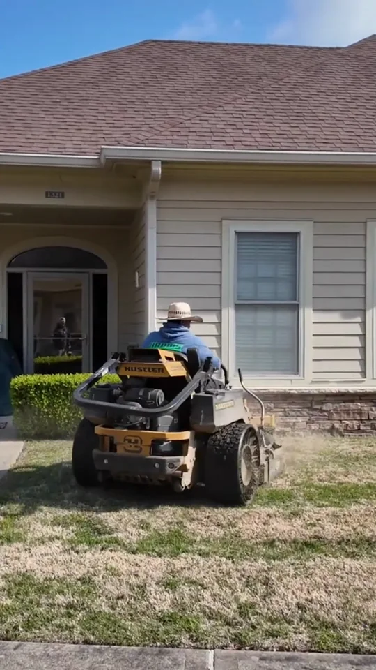 A mower operator wearing a Harris Landscaping Services shirt, shown in the showcase film.